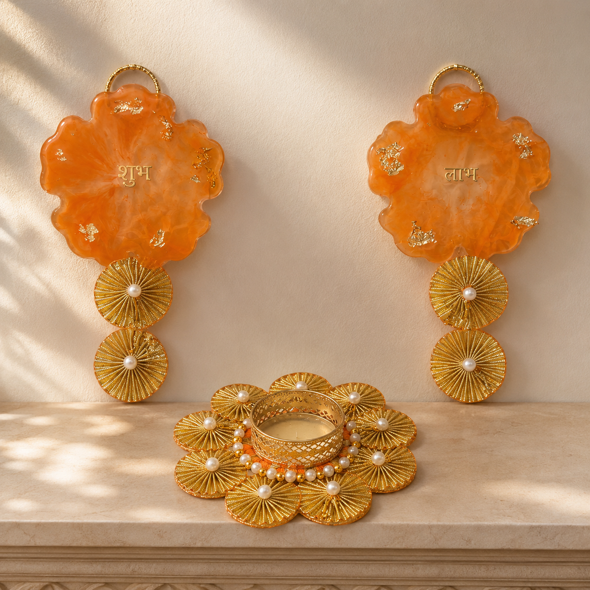 Orange resin Shubh Labh hangings displayed with a decorative tealight holder